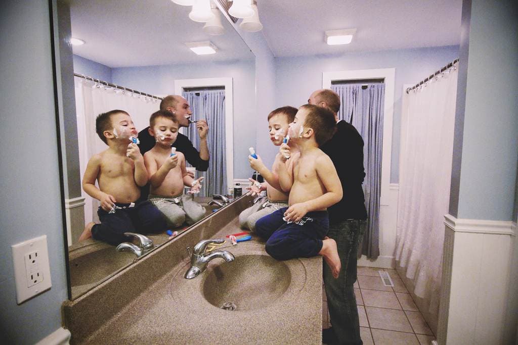 Dad and two sons shaving