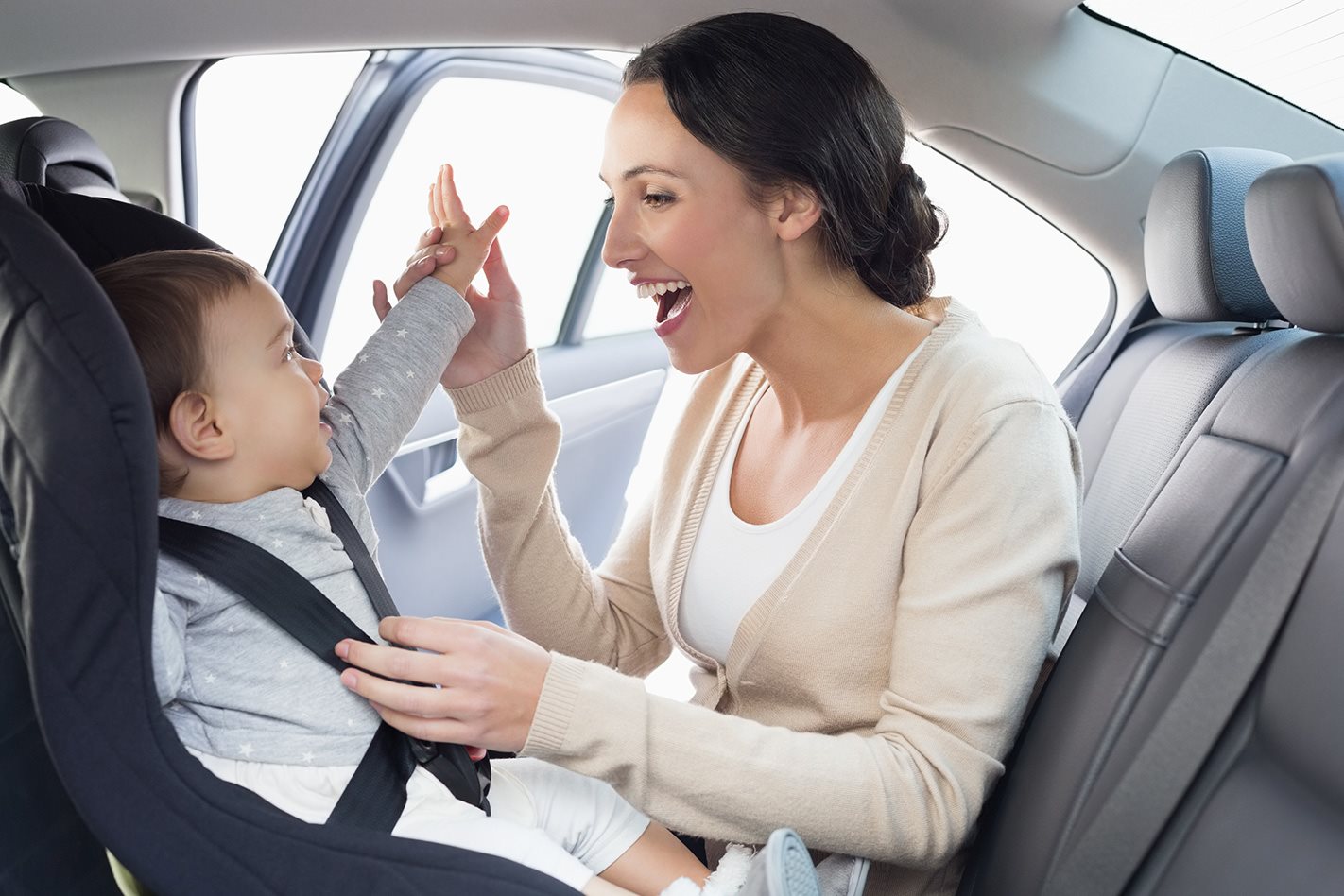 Woman getting her kid into the car