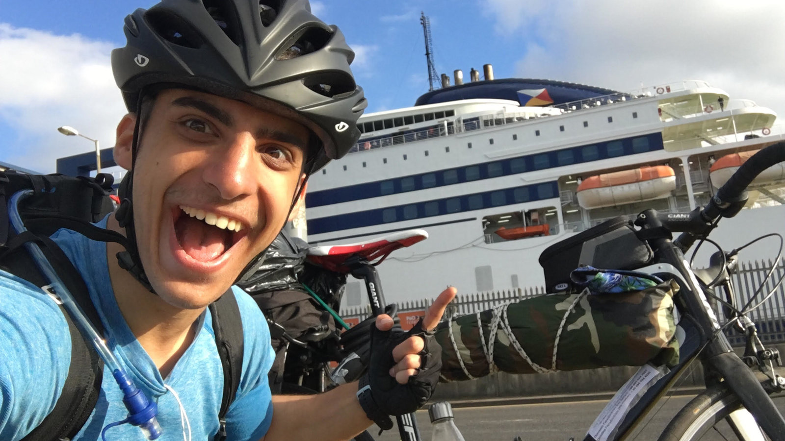 Kleon taking a selfie next to a giant boat on a port