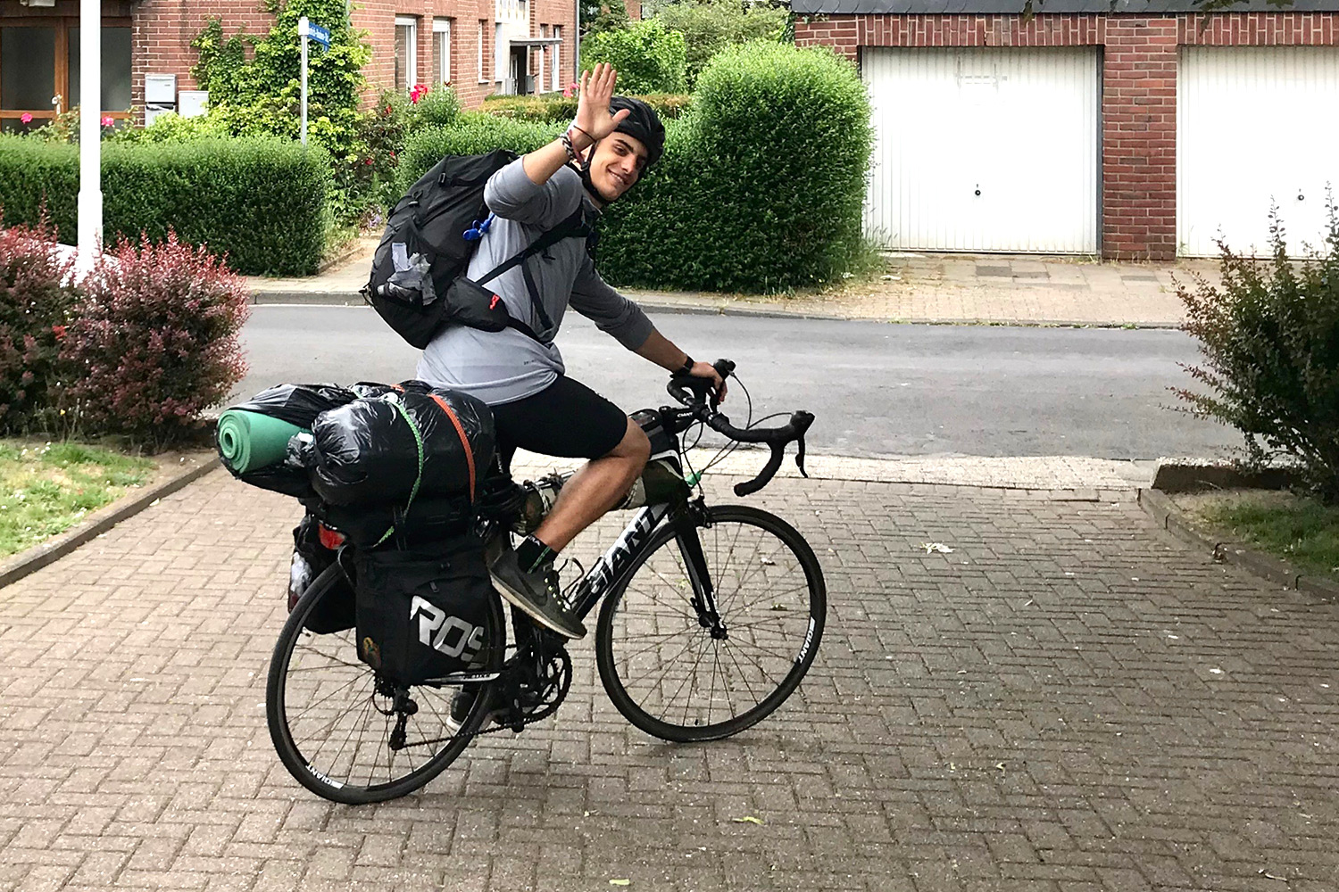 Kleon on his bike, waving at the camera