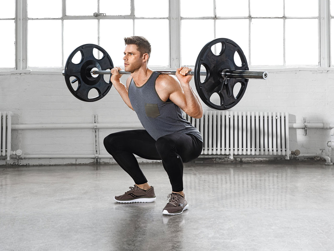 Jeremy Ethier, the founder of Built with Science, doing squats with weights