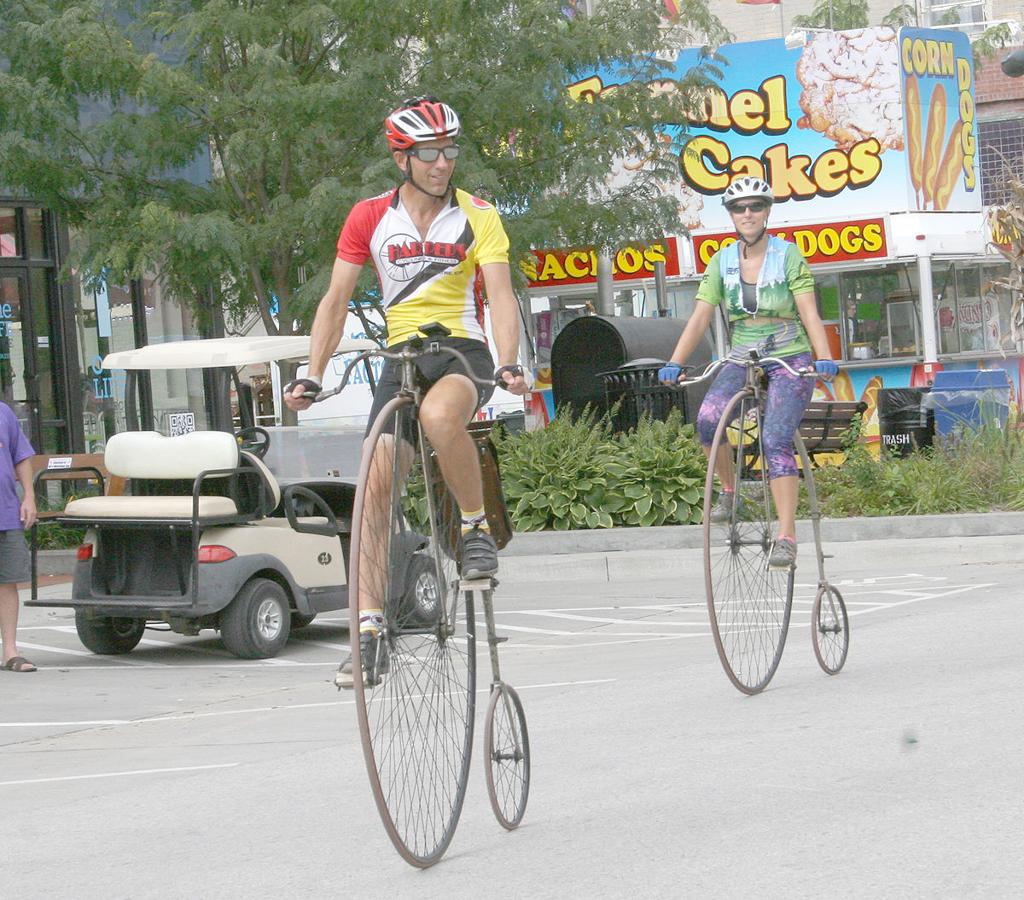 Randy Oleynik and his daughter riding their bikes in town