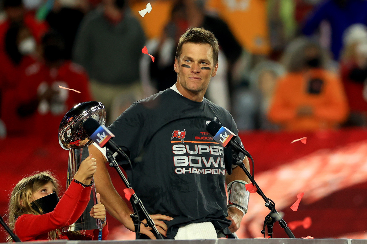 Tom Brady accepting the Lombardi Trophy after helping his team win Super Bowl LV.