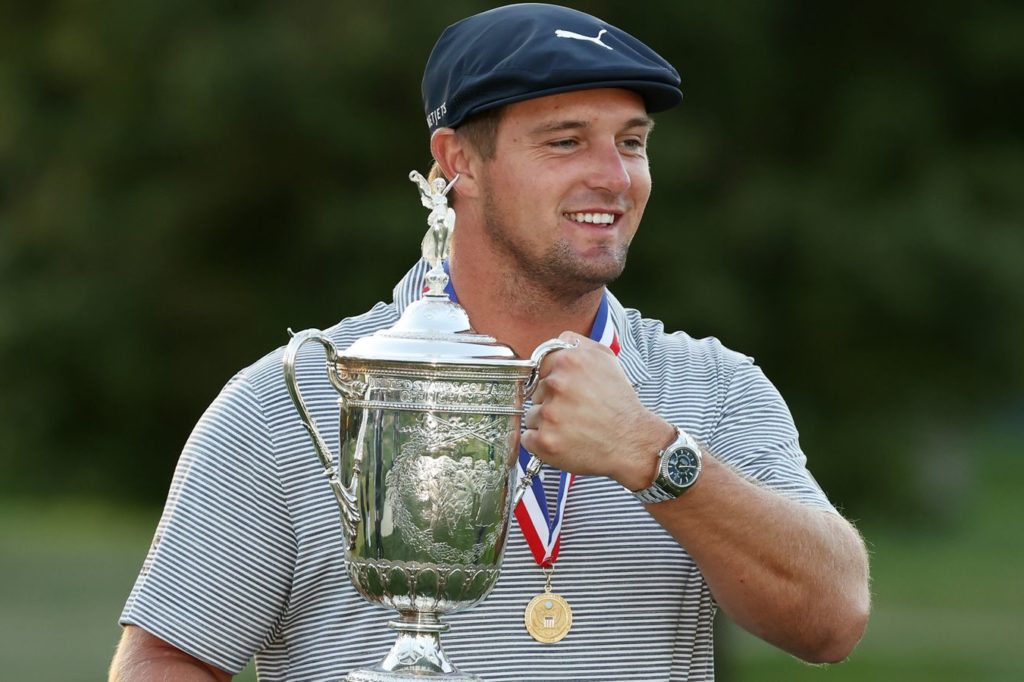 Bryson DeChambeau posing with his 2020 U.S. Open trophy.