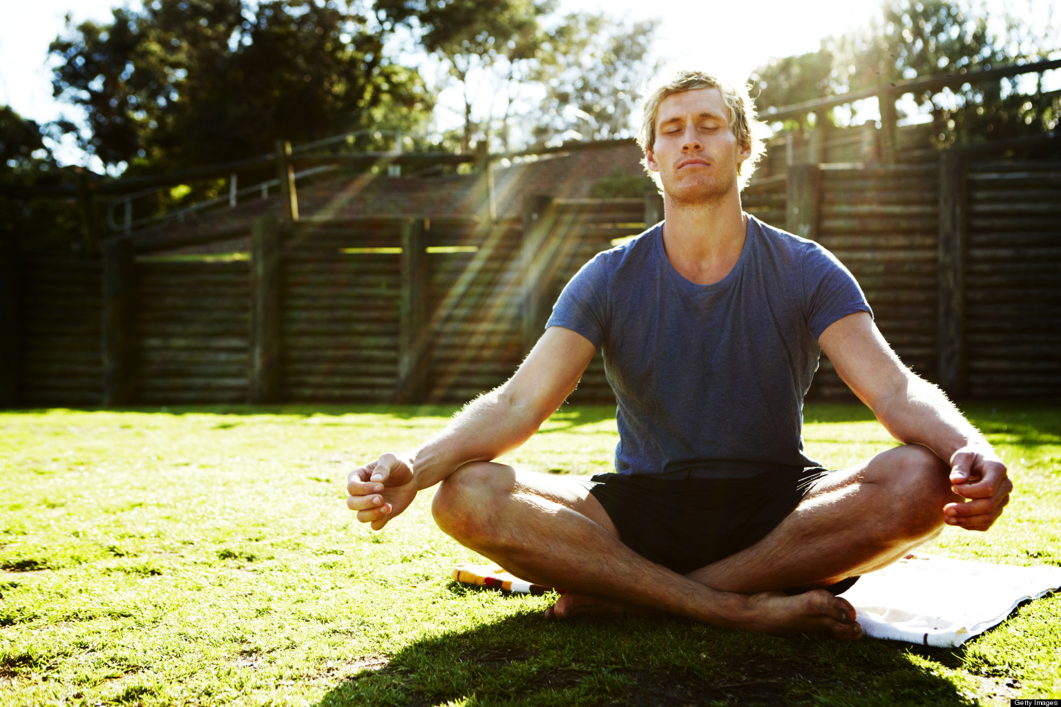 Young man meditating outdoors